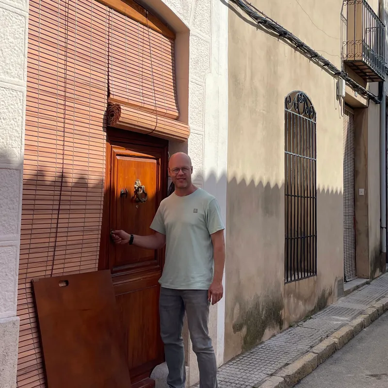 Jasper standing at his front door on a street in Xaló